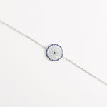 A modern take on a timeless charm, the Blue Evil Eye Bracelet blends shimmering zircon stones with deep blue crystals in a radiant circular design.