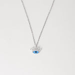 Meet your new favorite everyday necklace the Blue Eye with Lashes. Made from shiny fine silver, this little charm features a bright blue eye with sparkling baguette lashes that catch everyone’s attention.
