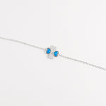 The Blue Heart Clover Bracelet is a delicate piece made from fine silver, adorned with shimmering zircon stones. Its charming four-leaf clover design features vibrant blue heart-shaped accents, symbolizing luck and love.