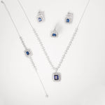 The Blue Royal Full Set is a striking celebration of elegance and sophistication. Crafted in fine silver, this luxurious set includes a regal necklace, bracelet, earrings, and ring—each adorned with deep blue stones framed by bright, shimmering zircon accents.