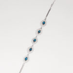 Discover the elegance of the Blue Topaz Bracelet, crafted with fine silver and real blue topaz stones. Each stone is surrounded by sparkling zircon accents, creating a stunning contrast that catches the light beautifully.