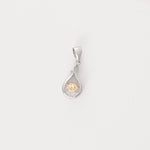 Graceful and glowing, the Crystal Twist Pendant features a soft teardrop shape in fine silver, gently twisted around a radiant crystal.