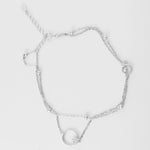 Shine bright with effortless charm. The Double Chain Circle Anklet features a double-layer fine silver chain with soft silver beads and a dazzling circle pendant tipped with shimmering stones.