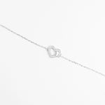 The Butterfly Heart Bracelet features a graceful heart outline adorned with sparkling zircon stones, gently touched by a tiny butterfly charm.