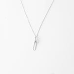 The Double Link Necklace in fine silver offers a sleek and modern look with its unique linked design.