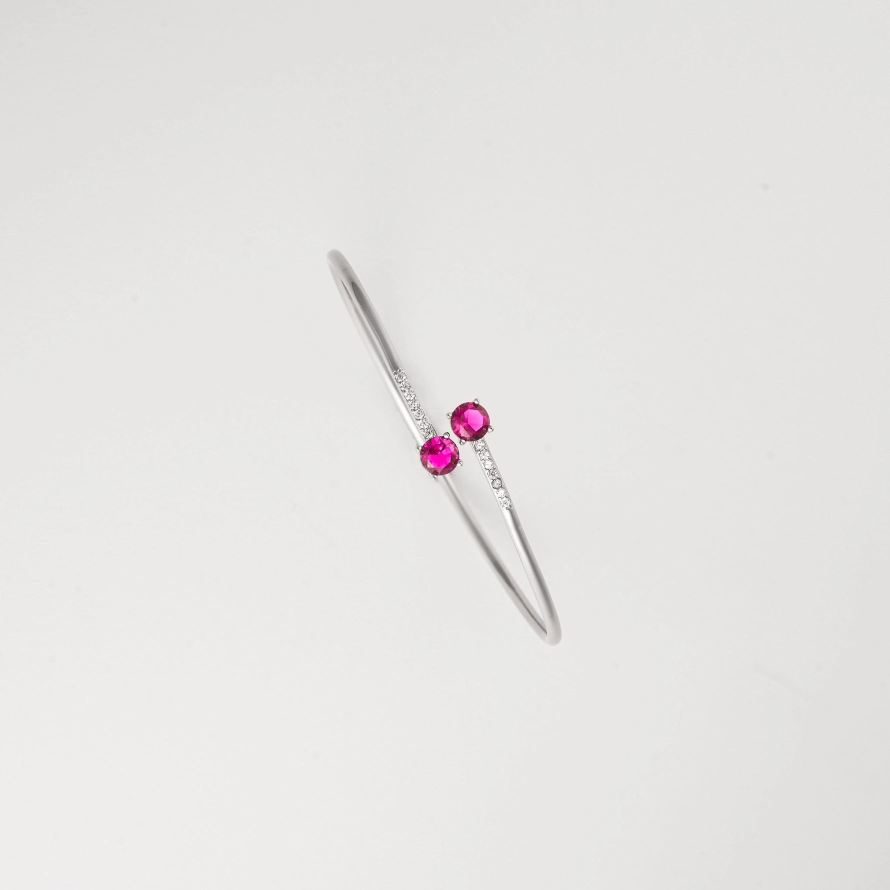 Deep red crystals paired with shining stones on sleek silver. The stunning red glow creates a warm, luxurious accent that complements any outfit, making it the perfect statement piece for both everyday wear and special occasions.