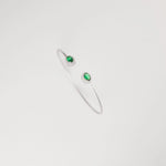 Emerald Glow Silver Bangle, featuring radiant green crystal stones and delicate zircon halos.