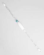 Silver bracelet with a blue gemstone on a light gray background for kids