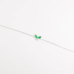 The Green Leaf Bracelet features two vibrant marquise-cut red stones shaped like delicate leaves, paired with shimmering zircon crystals.