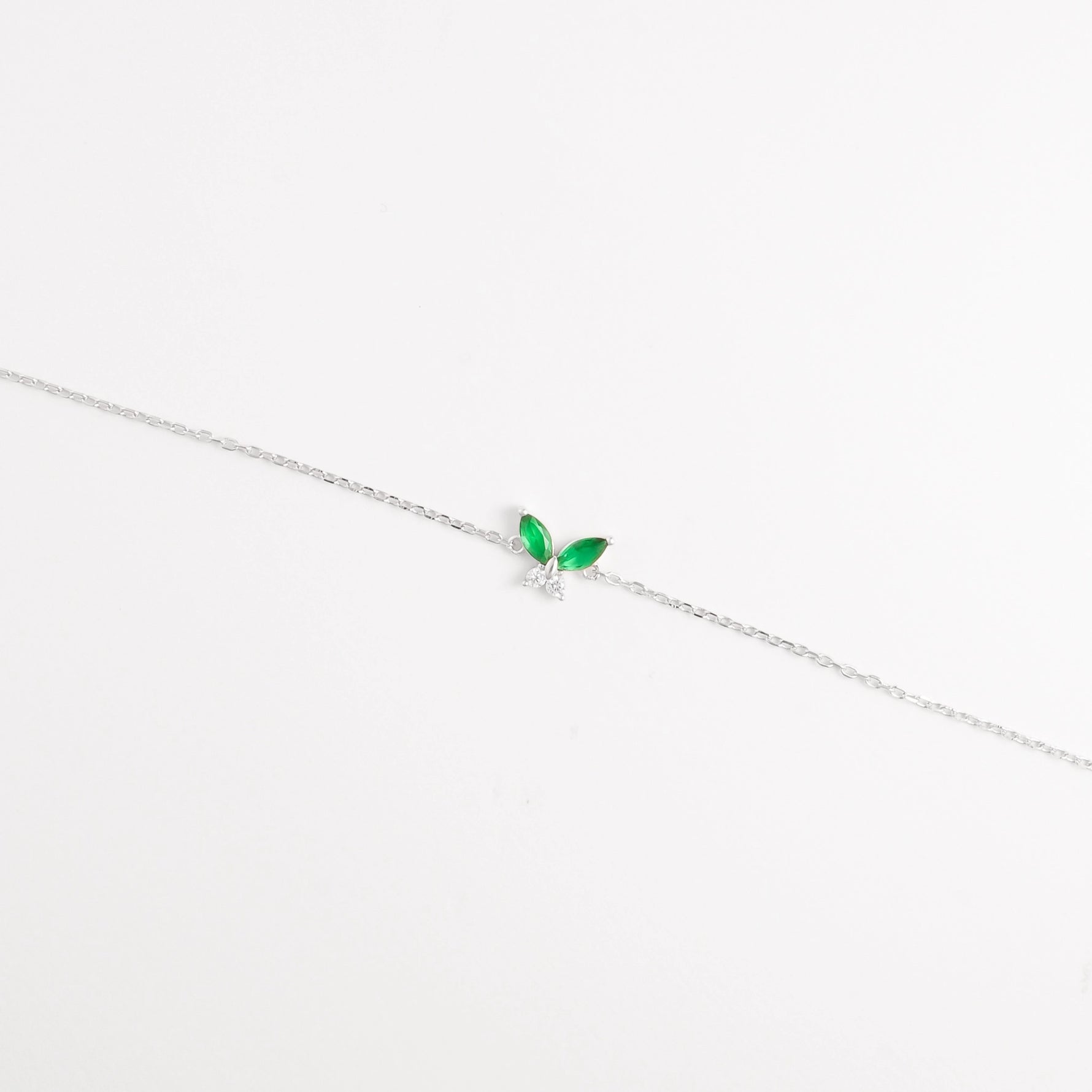 The Green Leaf Bracelet features two vibrant marquise-cut red stones shaped like delicate leaves, paired with shimmering zircon crystals.