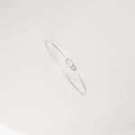 The sleek oval design creates a flattering silhouette around your wrist, complementing both casual and formal outfits with understated charm.