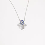 The Hamsa Blue Stone Necklace is a beautiful symbol of protection and good fortune, crafted from fine silver for lasting shine with a pop of bright blue stone and sparkling zircon, it’s the perfect mix of stylish and meaningful.