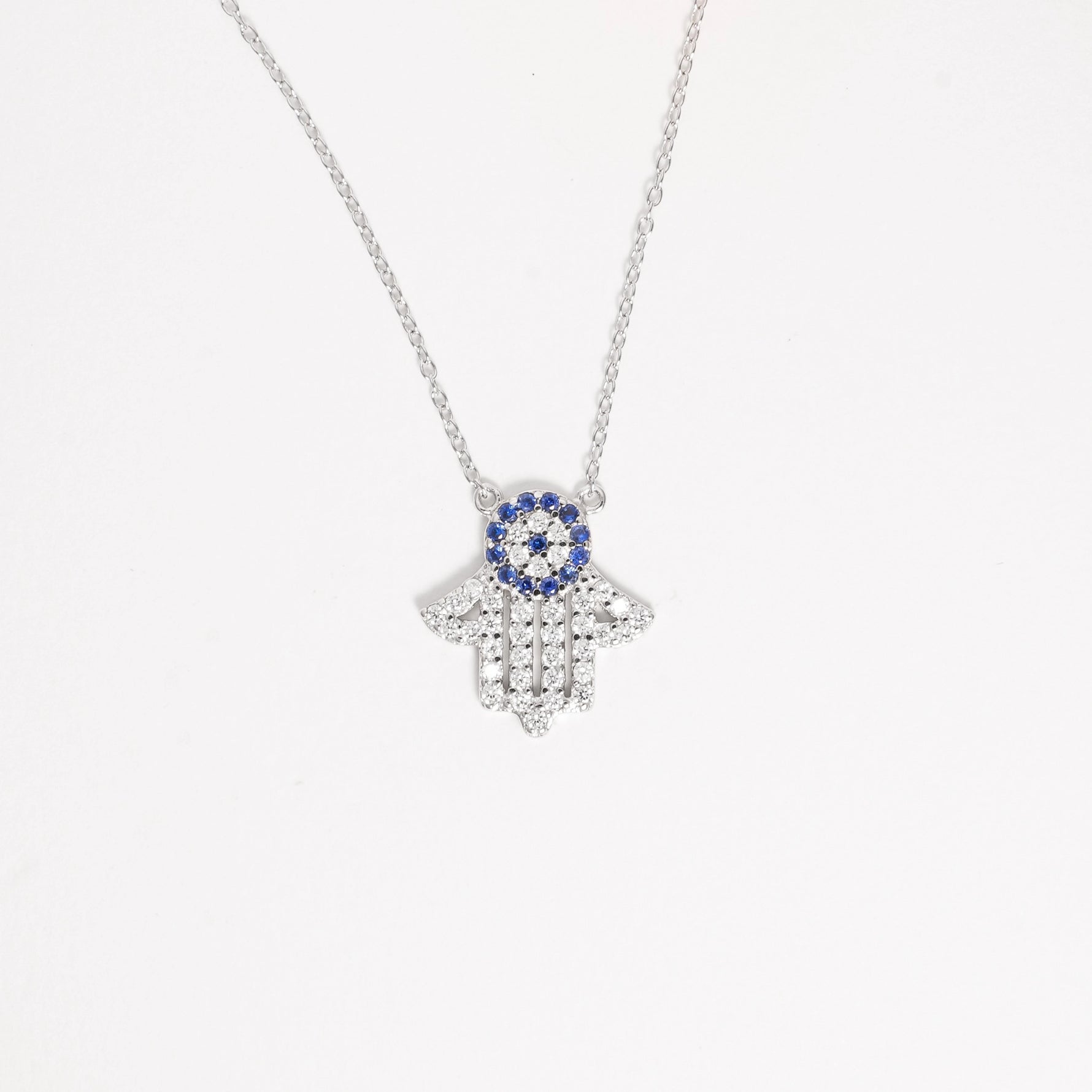 The Hamsa Blue Stone Necklace is a beautiful symbol of protection and good fortune, crafted from fine silver for lasting shine with a pop of bright blue stone and sparkling zircon, it’s the perfect mix of stylish and meaningful.