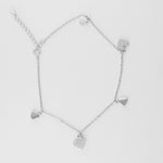 Add a touch of sparkle to your summer days with the Heart Charm Anklet. Made from fine silver, it features a brightening zircon-studded heart charms that shimmer with every step.