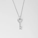 The Heart Key Necklace is a delicate symbol of love and elegance. Crafted from fine silver and sparkling zircon stones, this necklace features a key pendant shaped with a charming heart at its top.
