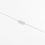 The Infinity Bracelet is a timeless fine silver piece designed with a sparkling infinity symbol encrusted with delicate zircon stones.