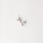 Add a touch of elegance to any outfit with our Pearl Orbit Earrings. Crafted from fine silver, these delicate studs feature beautiful pearls embraced by a modern orbit-inspired design.