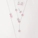The Pink Blossom Set is a stunning collection crafted from fine silver, featuring delicate floral designs with soft pink and lavender zircon stones. This elegant set includes earrings, a necklace, a bracelet, and a ring perfectly matched to add a fresh, feminine touch to any outfit.