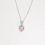 Delicate yet radiant, the Pink Heart Necklace ;is crafted in fine silver and features a soft pink heart-shaped crystal at its center, beautifully encircled by brightening zircon stones.
