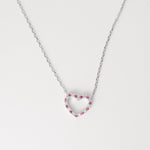 Sweet, minimal, and full of charm the Pink Heart Outline Necklace is crafted from fine silver and set with alternating bright pink and white zircon stones that delicately outline its open-heart shape.