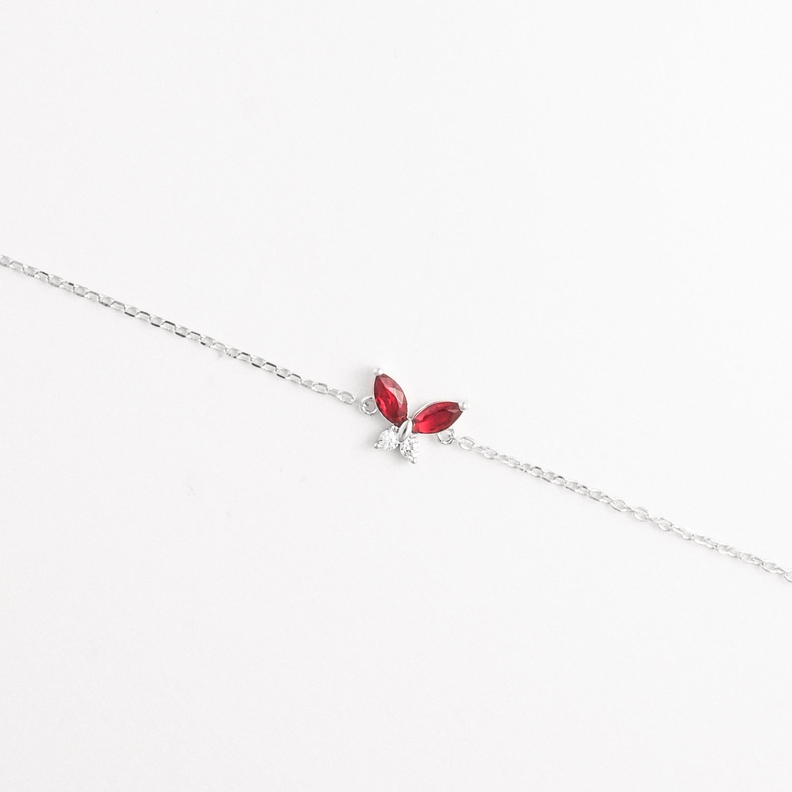 The Red Leaf Bracelet features two vibrant marquise-cut red stones shaped like delicate leaves, paired with shimmering zircon crystals.