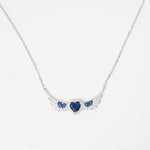 A symbol of love and elegance, the Sapphire Heart Trio Wing Necklace features three dazzling blue heart crystals embraced by wing-like curves of shimmering zircon stones. Set in pure silver, its winged design brings a graceful lift to any look.