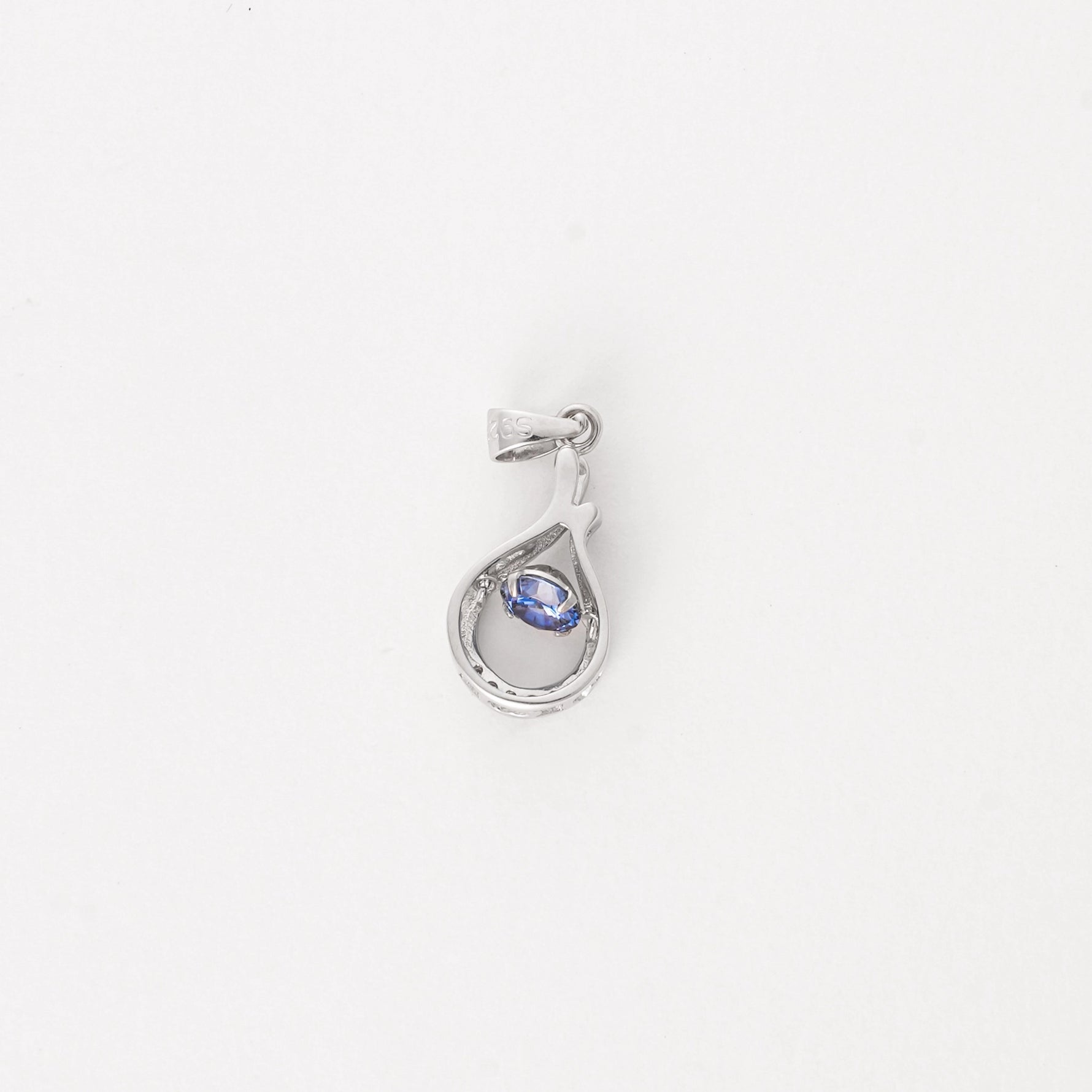Elegant and effortlessly unique, the Sapphire Twist Pendant brings a fresh summer feel to your look. Crafted from fine silver, this piece features a delicate teardrop twist design cradling a deep ocean-blue crystal at its center.
