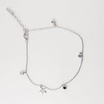 crafted from fine silver, this playful piece features a dainty star charm and colorful crystal accents that catch the light like summer rays.