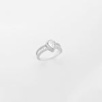 a stunning silver solitaire ring featuring a beautifully crafted, tear-shaped crystal stone, accented delicately with sparkling zircon details.