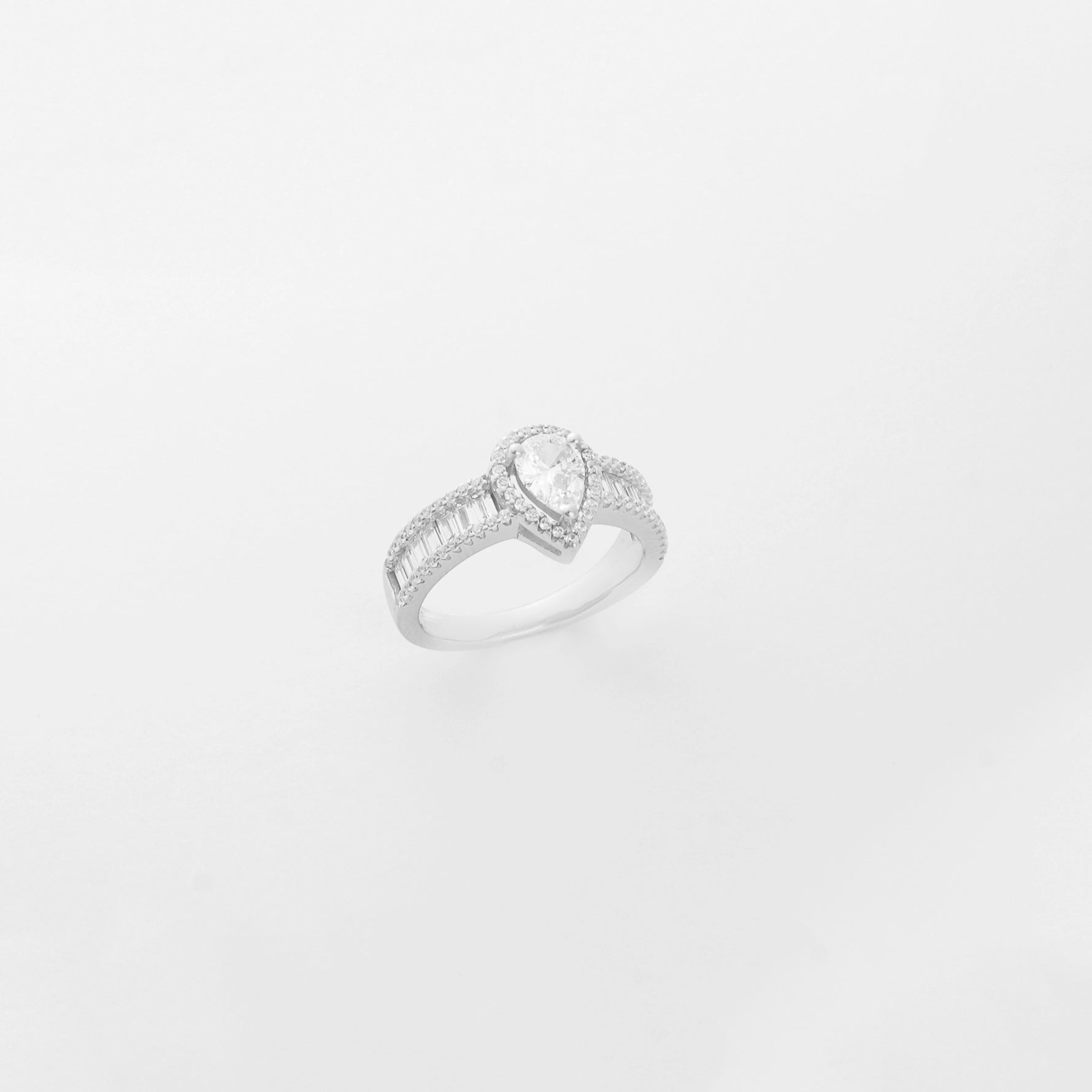 a stunning silver solitaire ring featuring a beautifully crafted, tear-shaped crystal stone, accented delicately with sparkling zircon details.