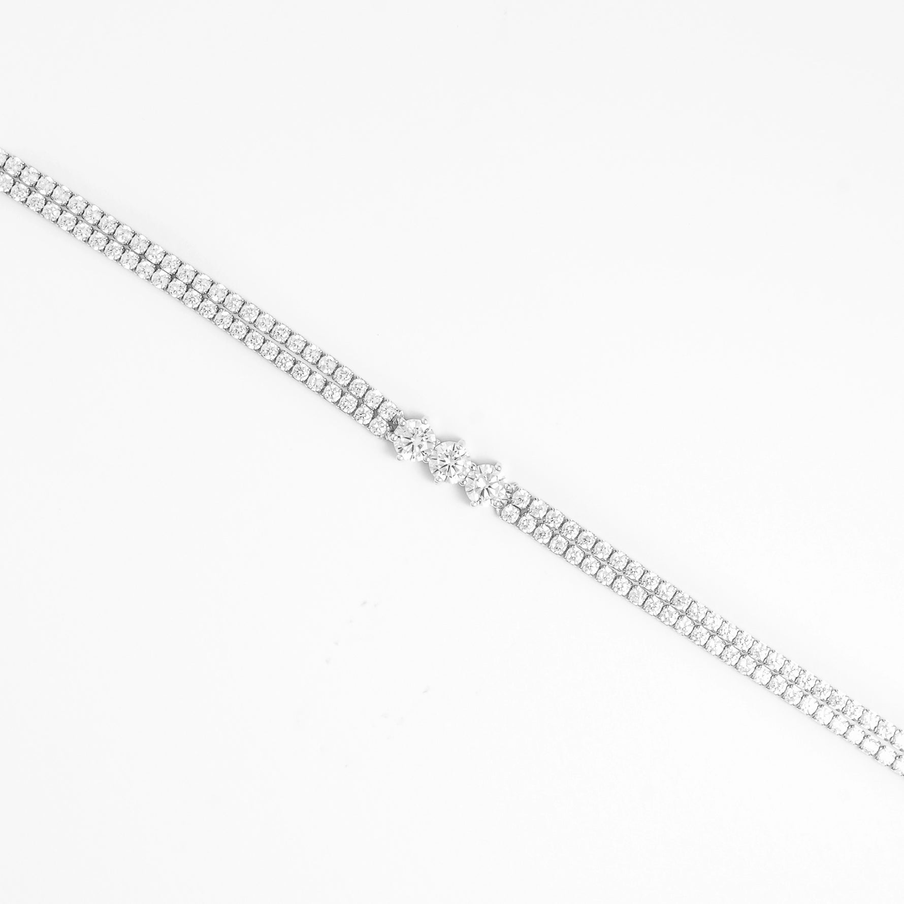 The Triple Glow Silver Bracelet features two rows of bright zircon stones leading to a stunning trio of larger center crystals.