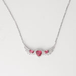 A symbol of love and elegance, the Triple Red Heart Wing Necklace features three dazzling pink heart crystals embraced by wing-like curves of shimmering zircon stones. Set in pure silver, its winged design brings a graceful lift to any look. A perfect blend of charm and sparkle made to brighten your neckline with every wear.