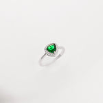 Charm silver ring featuring a sparkling green crystal stone, accented by tiny zircon stones.
