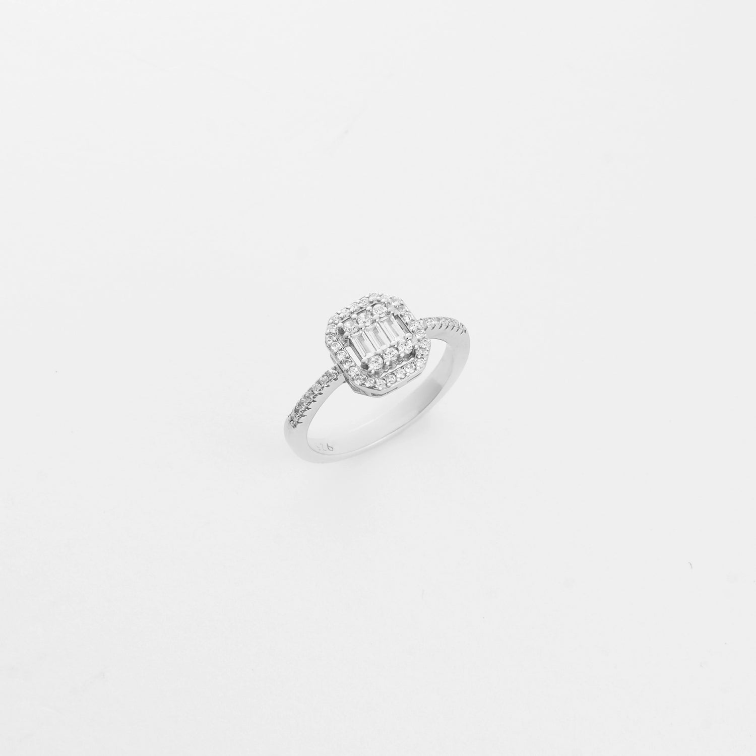 The Illusion Silver Ring showcases a rectangular center made of baguette-cut zircons, framed by two rows of sparkling round stones.