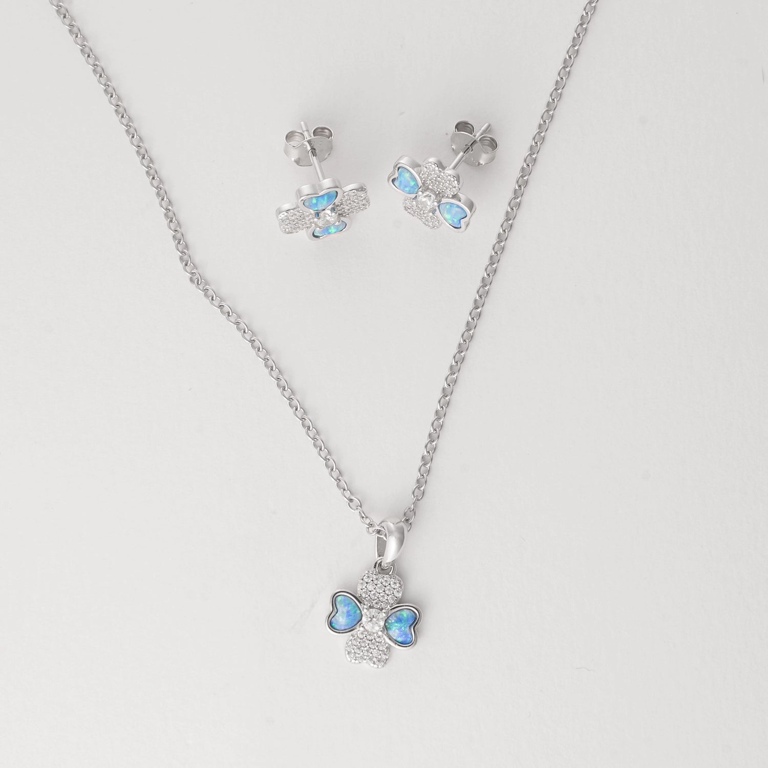 Delicate, playful, and full of charm the Blue Heart Clover Half Set brings a breezy summer vibe to your look. Crafted from fine silver and finished with sparkling zircon stones, this necklace and earring duo features soft blue heart details that shimmer like the ocean under sunlight.