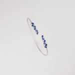 Add a pop of elegance with the Blue Mirage Silver Bangle. Adorned with vibrant blue crystal stones and sparkling zircons, it’s a perfect mix of bold and refined style.
