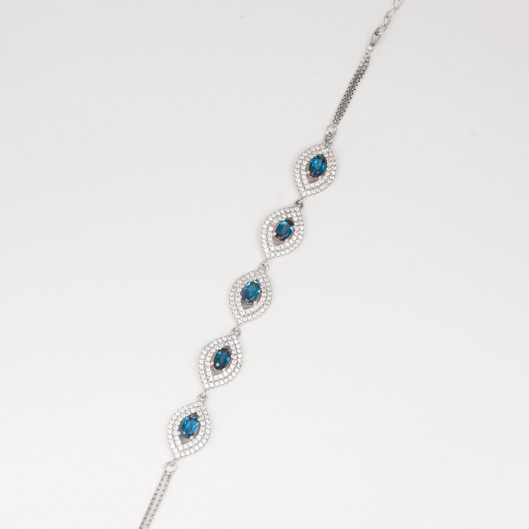 Discover the elegance of the Blue Topaz Bracelet, crafted with fine silver and real blue topaz stones. Each stone is surrounded by sparkling zircon accents, creating a stunning contrast that catches the light beautifully.