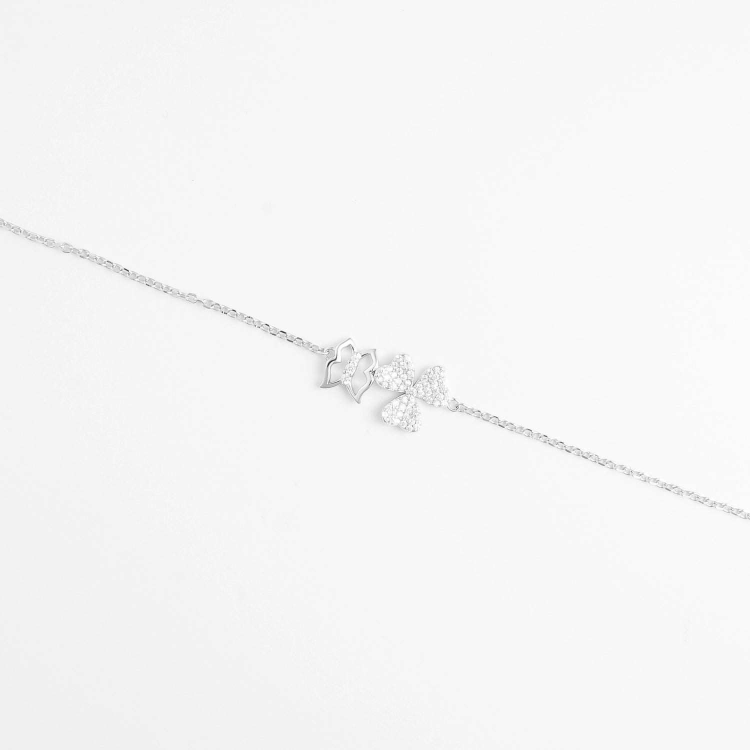 Delicate and full of charm, the Butterfly Whispers Bracelet features three graceful butterfly wings two covered in sparkling zircon stones and one in a sleek silver outline. Set on a fine silver chain, this bracelet captures the feeling of lightness and movement with a modern, elegant twist. Perfect for everyday shine or a soft, enchanting touch to your look.