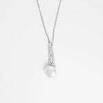 The Classic Pearl Necklace is a timeless piece crafted from fine silver and sparkling zircon stones. Its elegant design features a specular pearl-like charm that adds a touch of sophistication to any outfit.