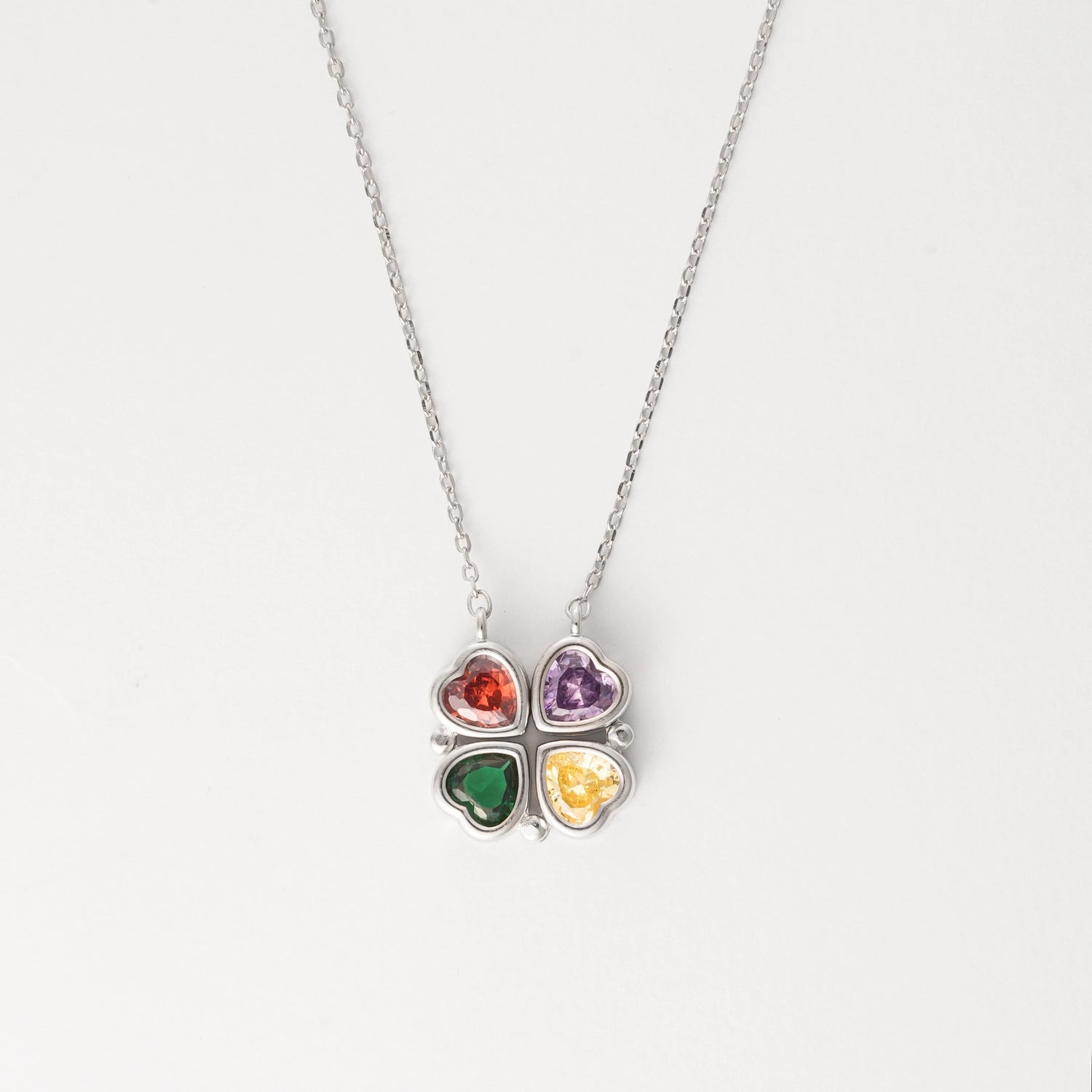 Discover the charm of the Rainbow Hearts Necklace, crafted from fine silver. This unique design offers two beautiful looks in one—wear it as a single row of vibrant hearts or transform it into a compact cluster.