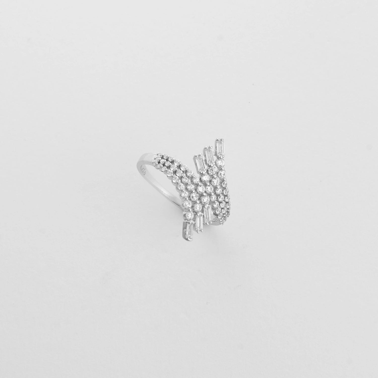 The Crystal Wave Ring features flowing rows of round zircon stones, rising into elegant baguette-cut accents.