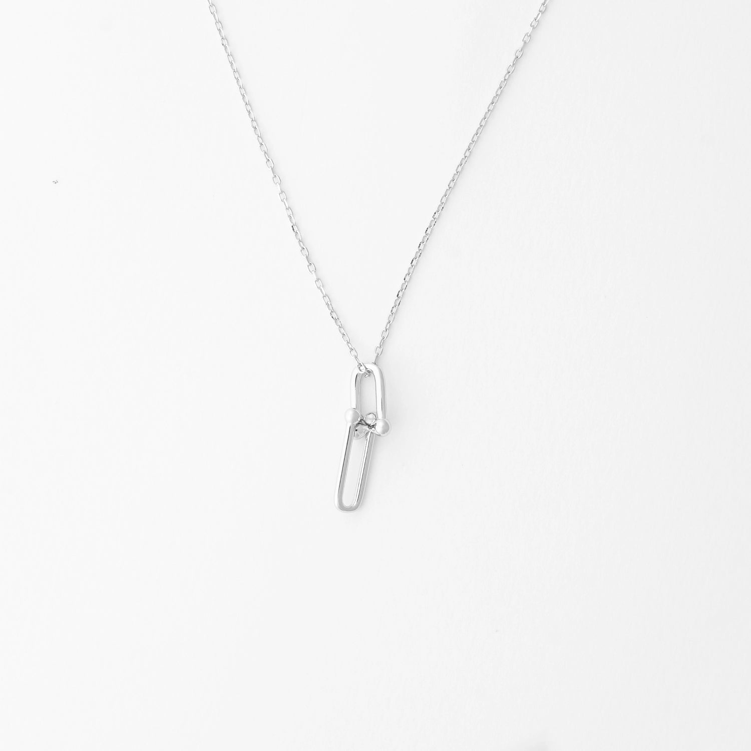 The Double Link Necklace in fine silver offers a sleek and modern look with its unique linked design.