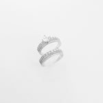The Eternal Bond Duo Twin ring set features two beautifully crafted silver bands—one crowned with a radiant center stone, the other fully lined with bright zircon stones. 