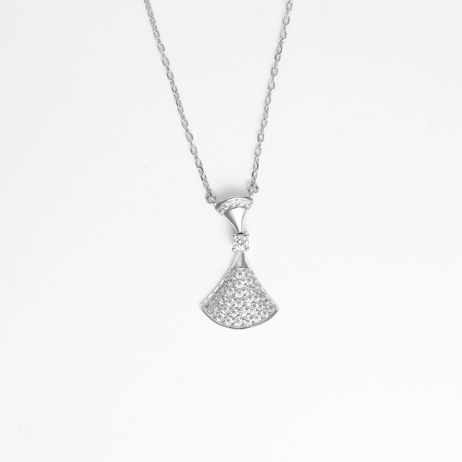 Graceful and eye-catching, the Fan Pendant Necklace brings a fresh twist to timeless elegance. Shaped like a delicate fan, this silver piece sparkles with layered zircon stones that catch the light from every angle.