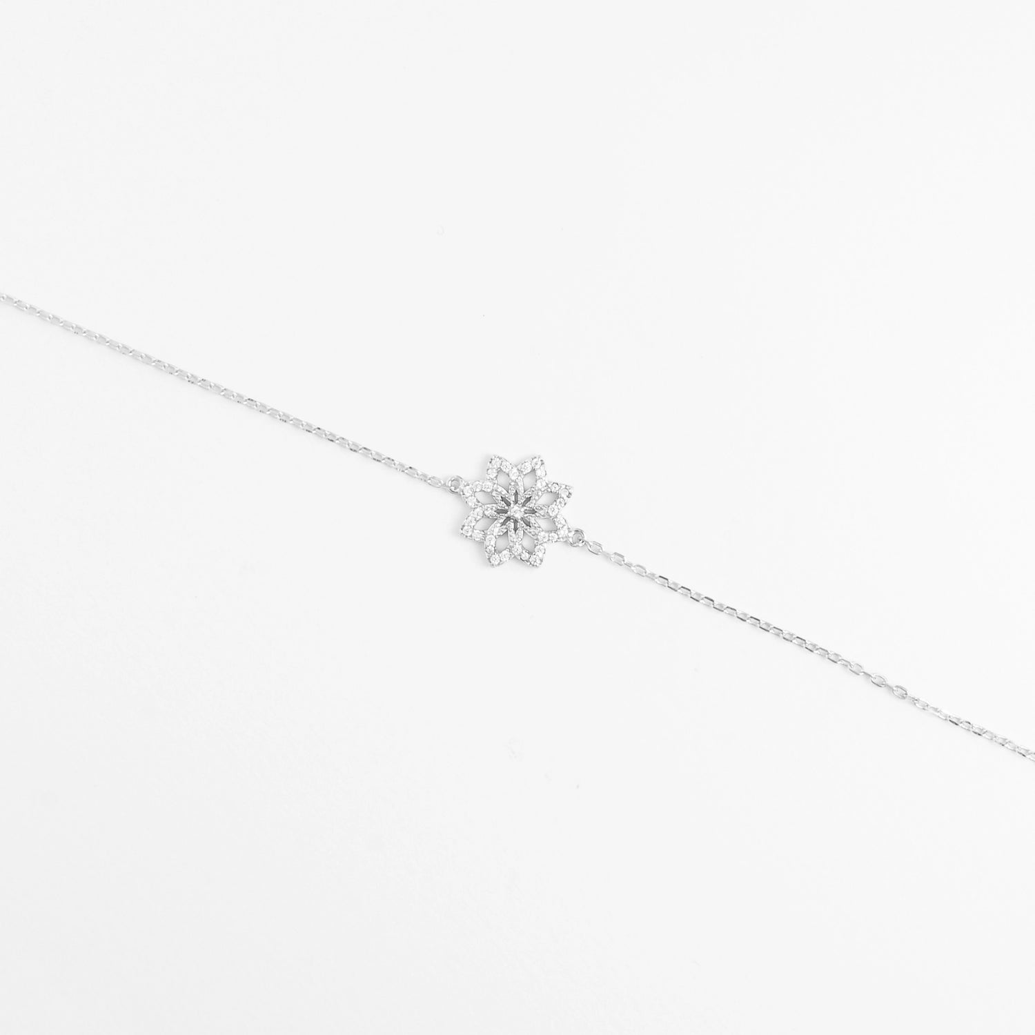 Delicate yet dazzling, the Floral Twist Bracelet blooms with charm. Its elegant flower-shaped design is brought to life with brightening zircon stones and shimmering crystals, all set in pure silver.