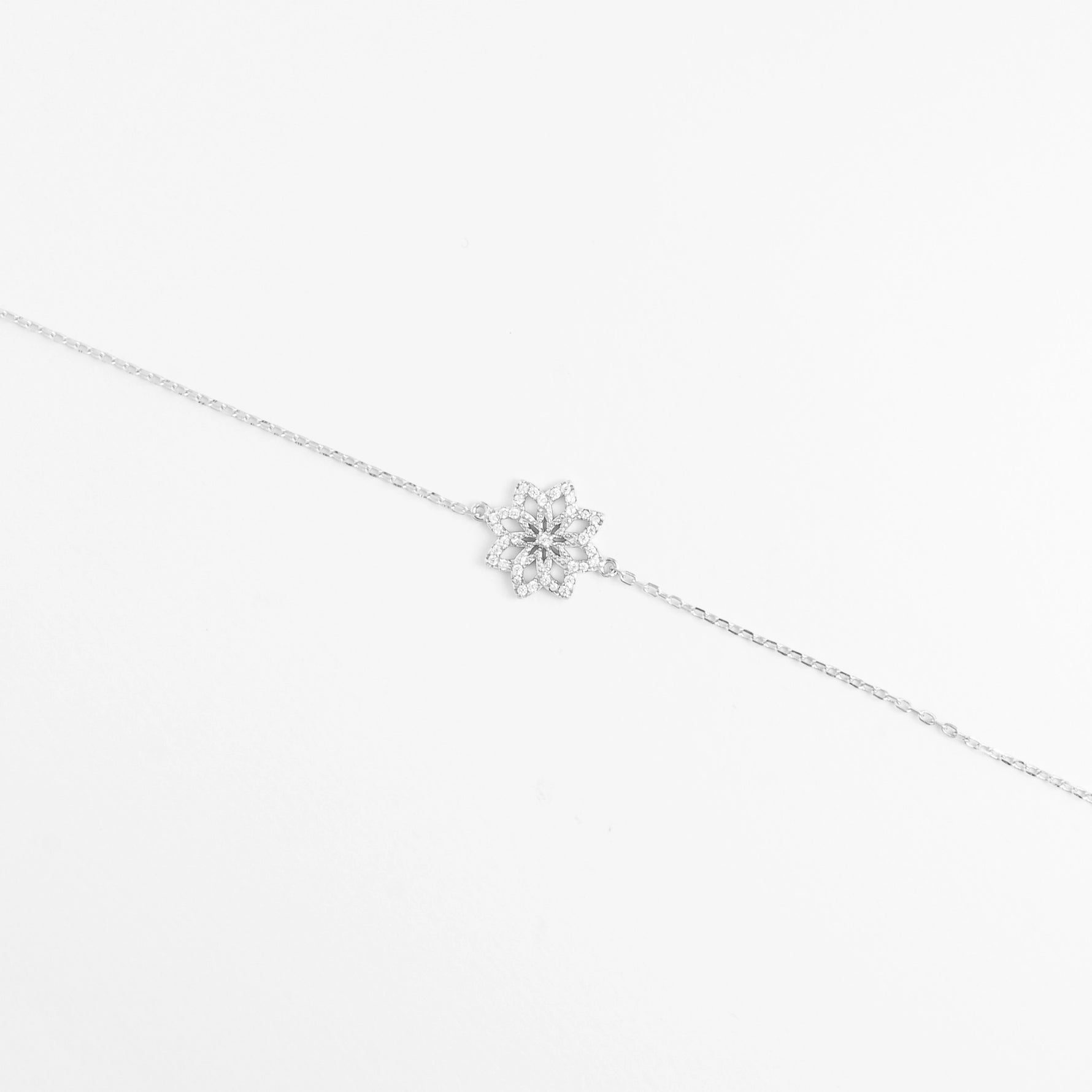 Delicate yet dazzling, the Floral Twist Bracelet blooms with charm. Its elegant flower-shaped design is brought to life with brightening zircon stones and shimmering crystals, all set in pure silver.