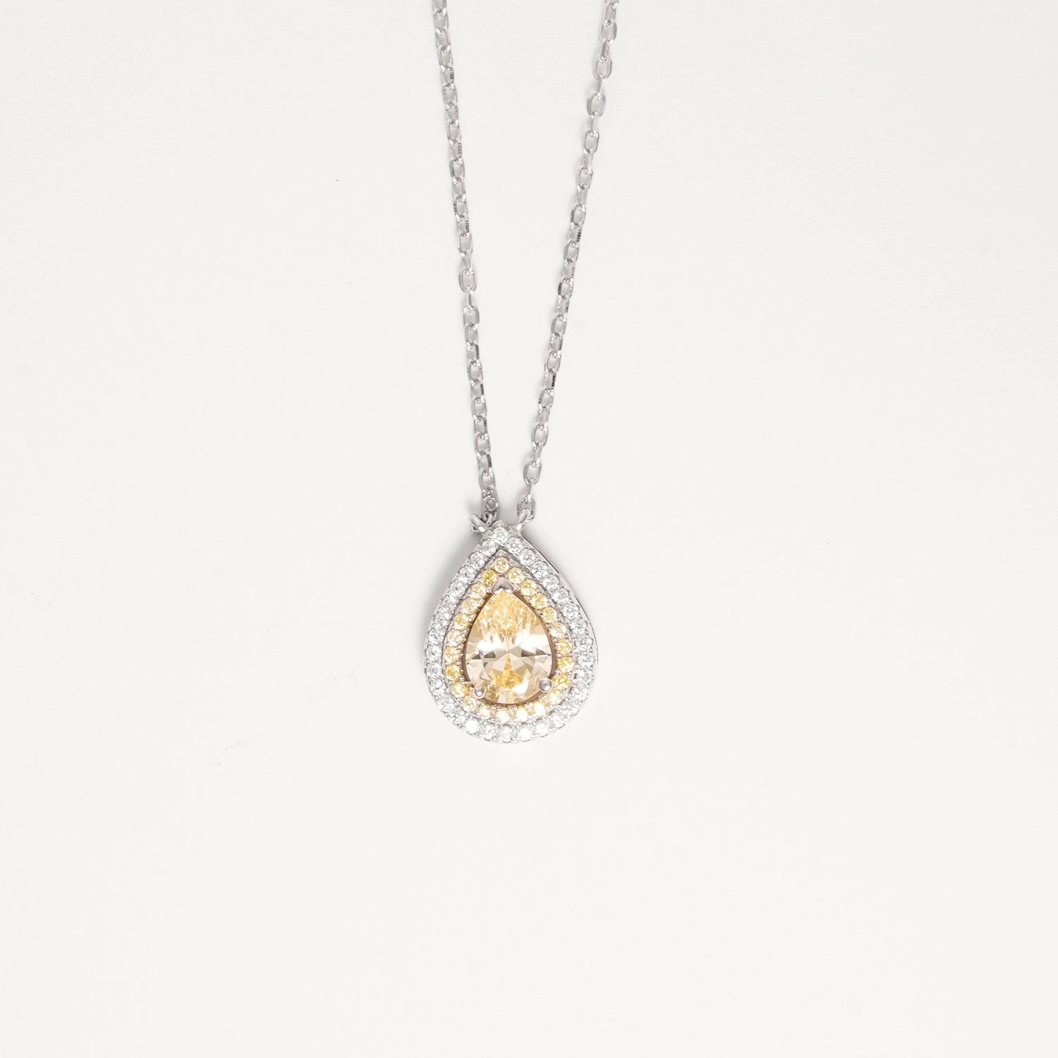 The Golden Teardrop Necklace radiates timeless elegance with its fine silver craftsmanship and sparkling zircon stones. Featuring a stunning golden teardrop center framed by brightening zircon accents, this necklace adds a warm, graceful glow to any look.