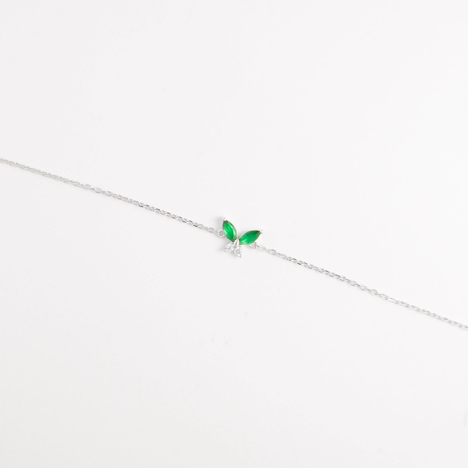 The Green Leaf Bracelet features two vibrant marquise-cut red stones shaped like delicate leaves, paired with shimmering zircon crystals.