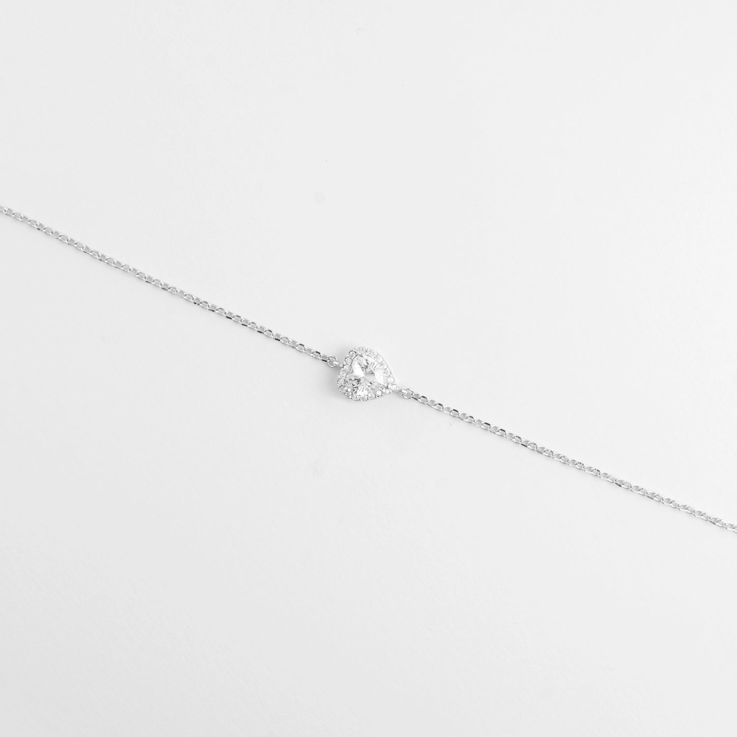 The Halo Heart Bracelet showcases a radiant crystal heart at its center, framed by a halo of shimmering zircon stones