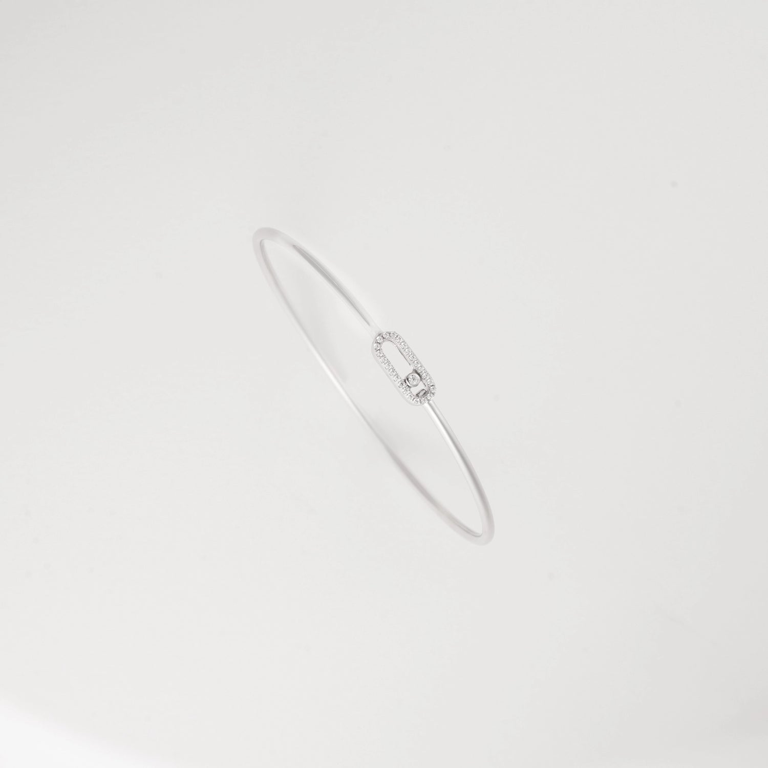 The sleek oval design creates a flattering silhouette around your wrist, complementing both casual and formal outfits with understated charm.